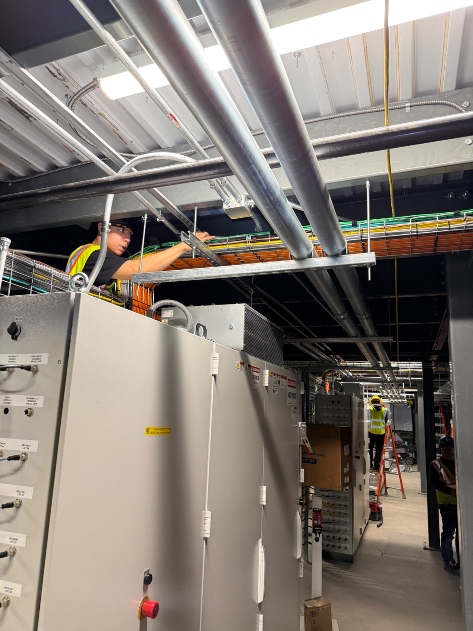 Commercial low-voltage cable pathway installation above equipment